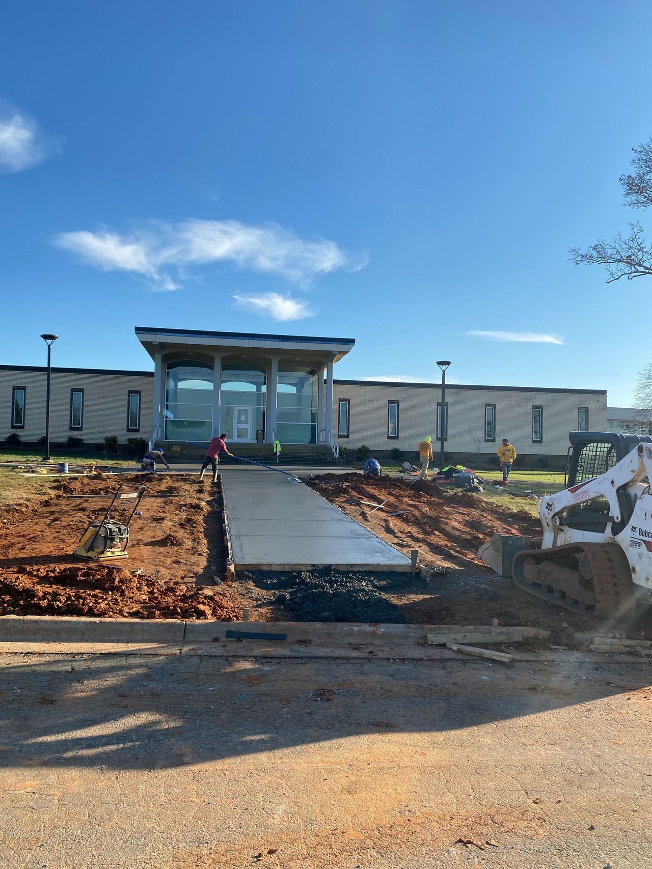 New concrete walkway leading to a building entrance