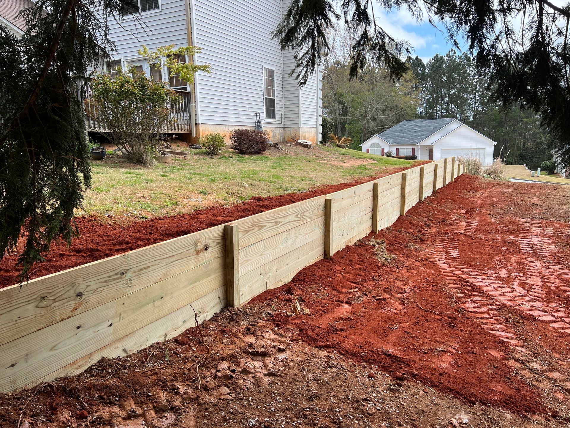 New timber retaining wall on a sloped lot