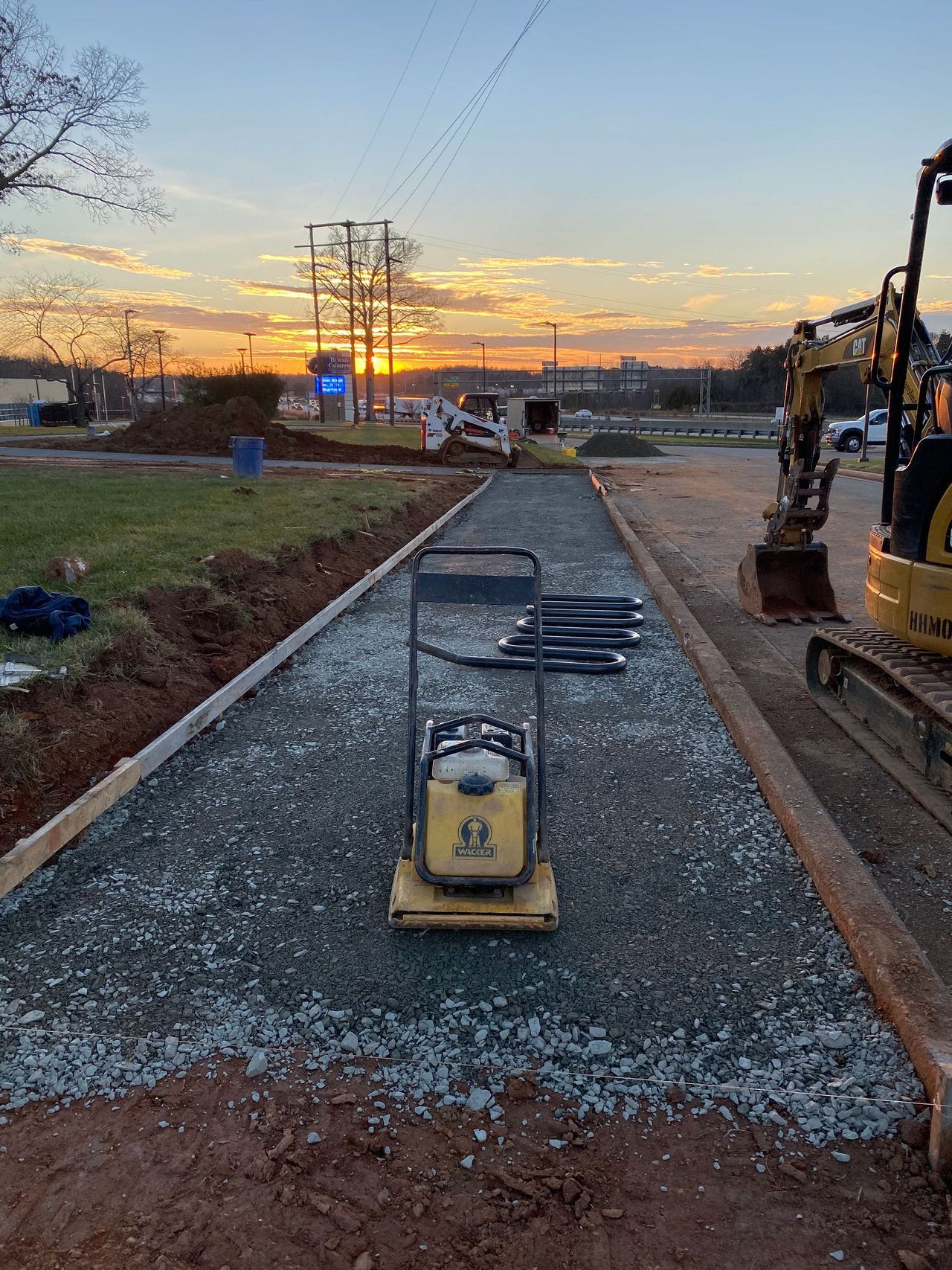 Plate compactor preparing the gravel base before a concrete pour