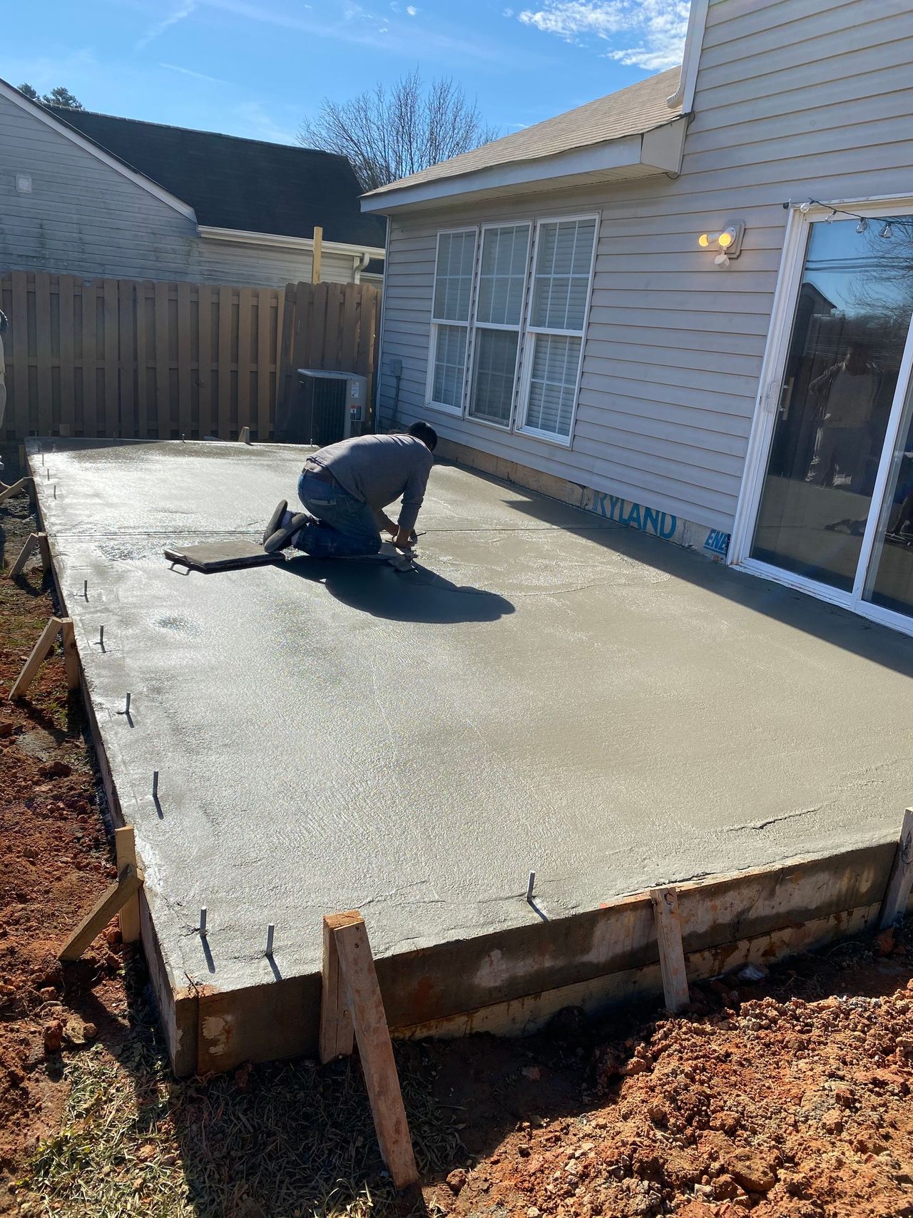 Finisher smoothing a freshly poured concrete slab