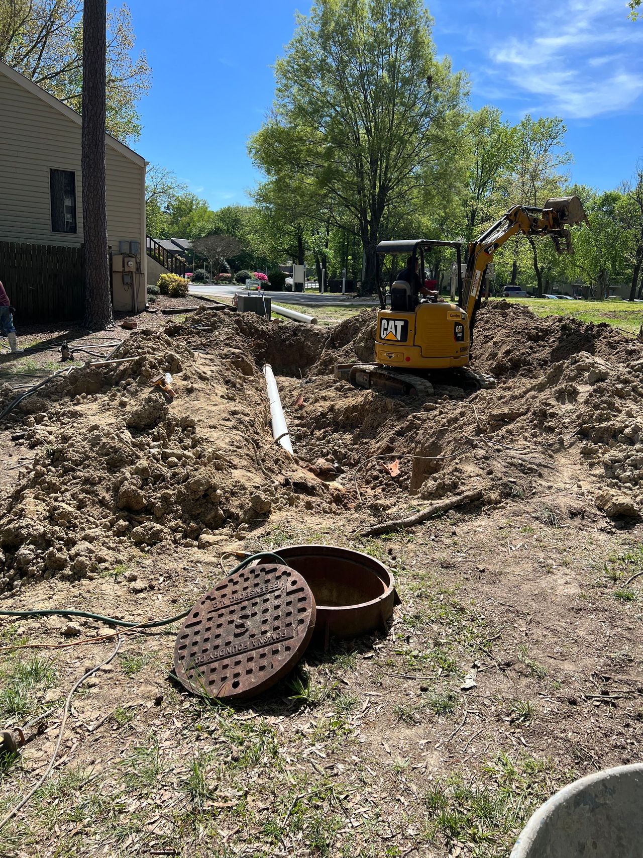 Excavator digging a drainage trench